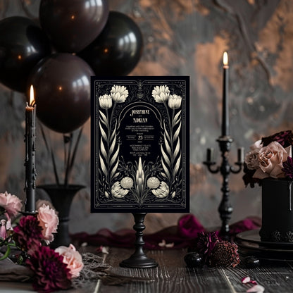 A Gothic invitation is placed in a dark, festive setting with black balloons, candles, and deep floral accents. The mysterious, vintage atmosphere enhances the mood of the invitation. The names and event details are centered.