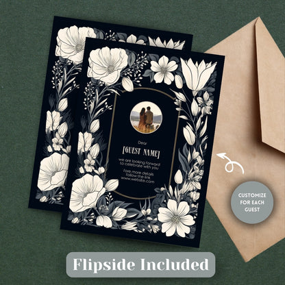 The back of the Gothic invitation, showcasing an optional space for a personal image upload, displayed alongside a tan envelope on a wooden surface.